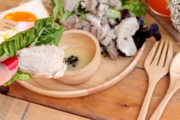 soft-boiled egg on toast with sliced pork tenderloin.