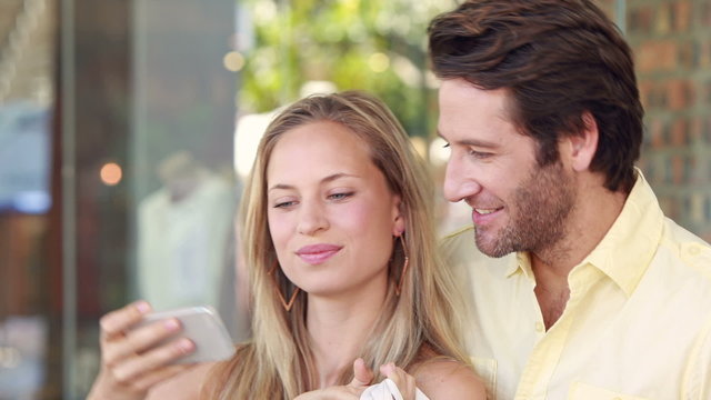 Happy couple taking selfie with smartphone