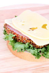 Sandwich with cheese, bacon and salad leaf