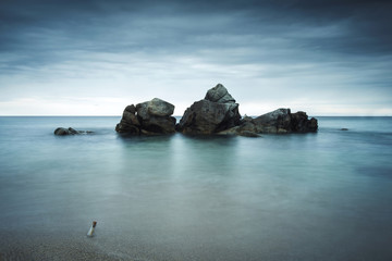Minimalist seascape with message in a bottle