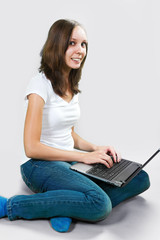 Student young girl with laptop computer on gray background. color image 