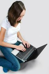 Student young girl with laptop computer on gray background. color image 