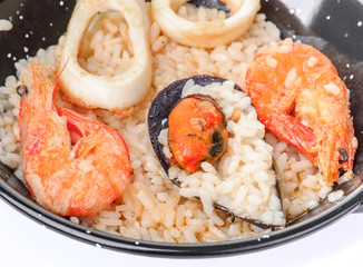 serving homemade paella in mini freshly cooked paella