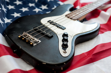 Vintage Bass guitar body on american flag background. selective focus image with shallow depth of field