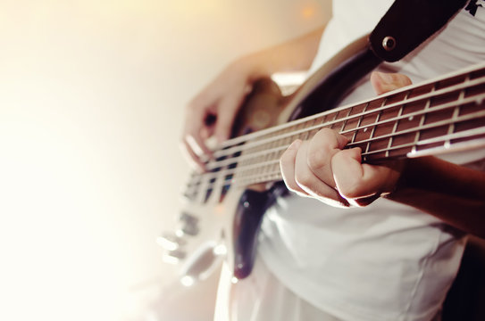 Unrecognizable man playing five string bass guitar. color image in horizontal orientation