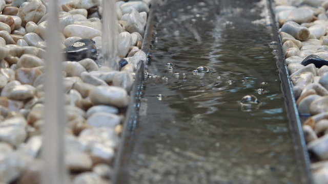 Water fountain flowing on rocks