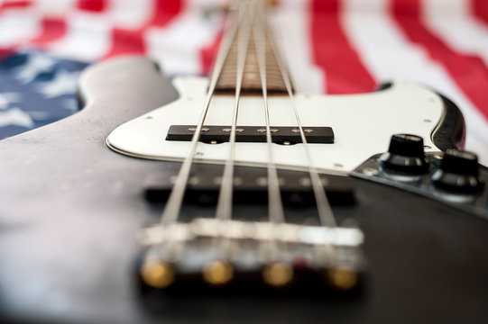 Vintage Bass guitar body on american flag background. selective focus image with shallow depth of field