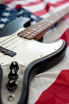 Vintage Bass guitar body on american flag background. selective focus image with shallow depth of field