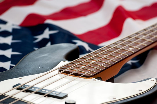 Vintage Bass guitar body on american flag background. selective focus image with shallow depth of field