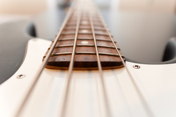 Classic black and white bass guitar body close up. color image