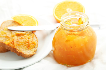 Fototapeta na wymiar Bread with orange jam on white background