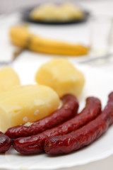 Fried sausages and boiled potatoes