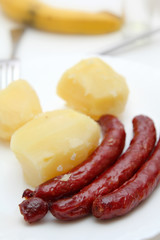 Sausages and potatoes on plate