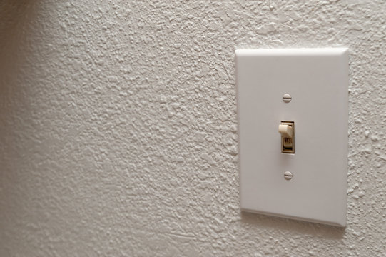 Light switch on the wall. selective focus image in color in horizontal orientation