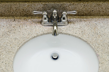Retro style Chrome Faucet and old sink in bathroom. Selective focus on a tap
