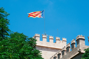 Valencia flag over Lonja de la Seda. Valencia, Spain