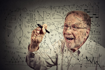 Senior man scientist with glasses writing secret formula with pen