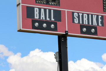 Part of a red scoreboard at a New Mexico softball field that says ball strike