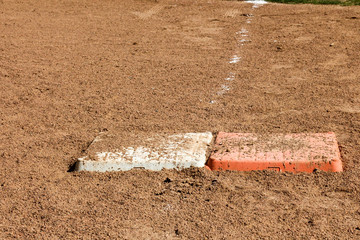 Close up of first base and an orange safety base at a softball field in New Mexico © karagrubis