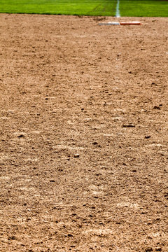 First person view looking at first base with the orange safety base at a softball field