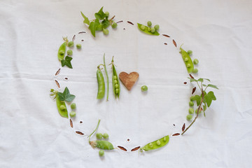 Green peas on the table with a white tablecloth