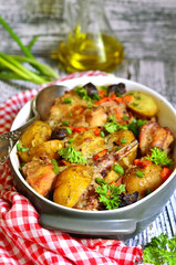 Rabbit baked with young potato in a cream.