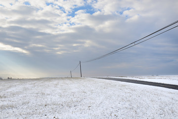 Snowy Landscape with Lonely Road and Dramatic Sky