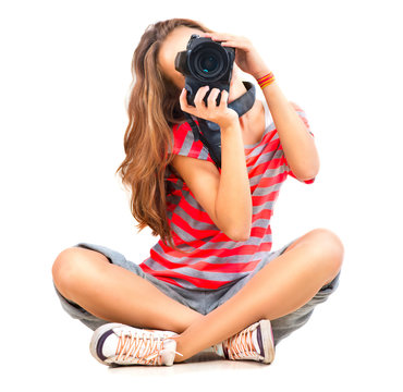 Beauty teenage girl photographer sitting over white background