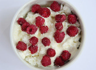 cup with cream cheese and raspberries
