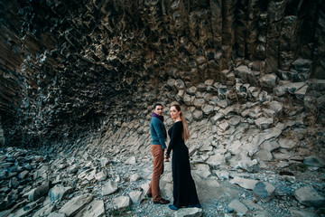 young couple on the background of rocks.