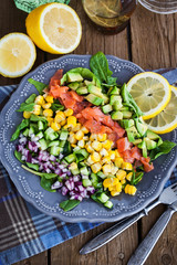 Salmon, avocado, corn, cucumber and onion salad