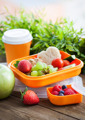 Lunch box with sandwich, cookies, veggies and fruits