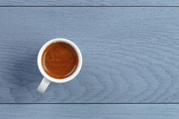 cup of fresh espresso on vintage blue table