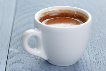 cup of fresh espresso on vintage blue table