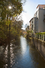 Fototapeta premium Munich, Germany - cityscape, houses on Isar canal near Englischer Garten with water reflections