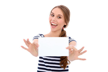 Fototapeta premium Student girl showing white blank sheet - copy space, isolated over background