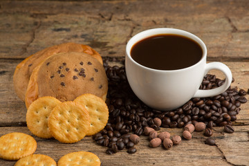 Cup of coffee on a wooden board and biscuits