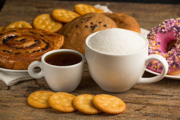 Cup of coffee on a wooden board and biscuits