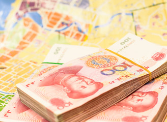 Ready for travel with china currency on blurry map background