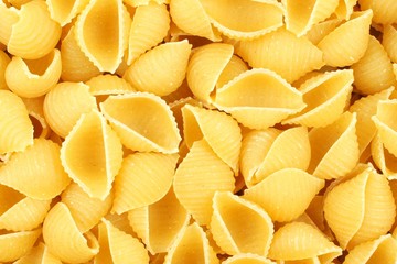 Full background of dry uncooked rotini pasta
