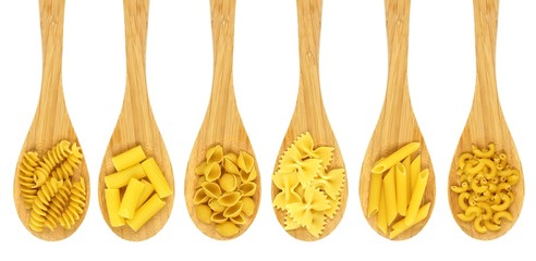 Wooden cooking spoons filled with various types dry pasta - Powered by Adobe
