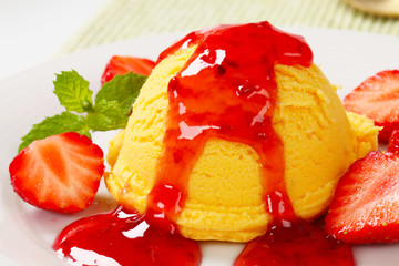 Scoop of ice cream with strawberry sauce