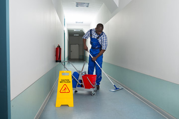 Male Janitor Cleaning Floor