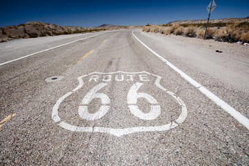 Route 66 pavement sign with Mojave desert 