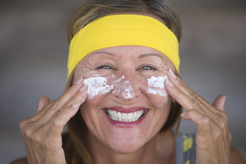 Skin care lotion joyful mature woman