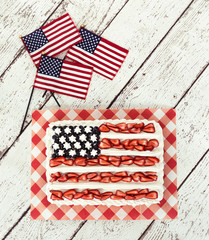 Fototapeta na wymiar Patriotic American flag cake and decorative mini flags