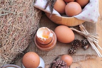 soft-boiled egg and eggs on wood background