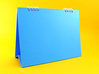 blue calendar blank on yellow background