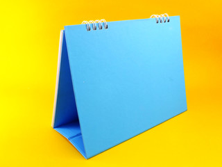 blue calendar blank on yellow background