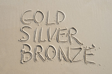 Gold Silver Bronze Message on Smooth Sand